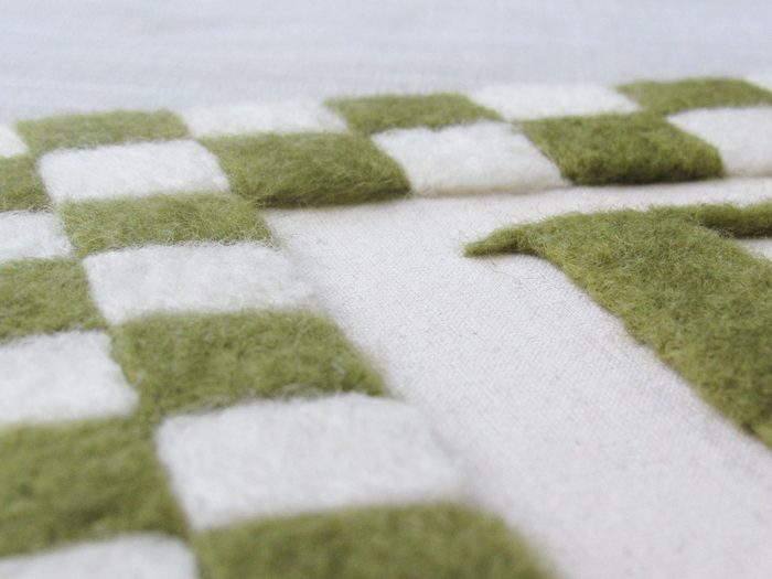 Relevo do quadriculado em lã verde e cru
